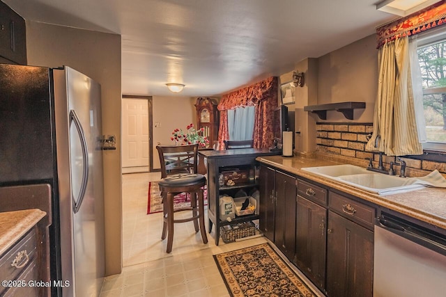 5518 Crooked St, Galway, NY 12074 - kitchen with appliances with stainless steel finishes, a sink, open shelves, light floors, and dark brown cabinetry
