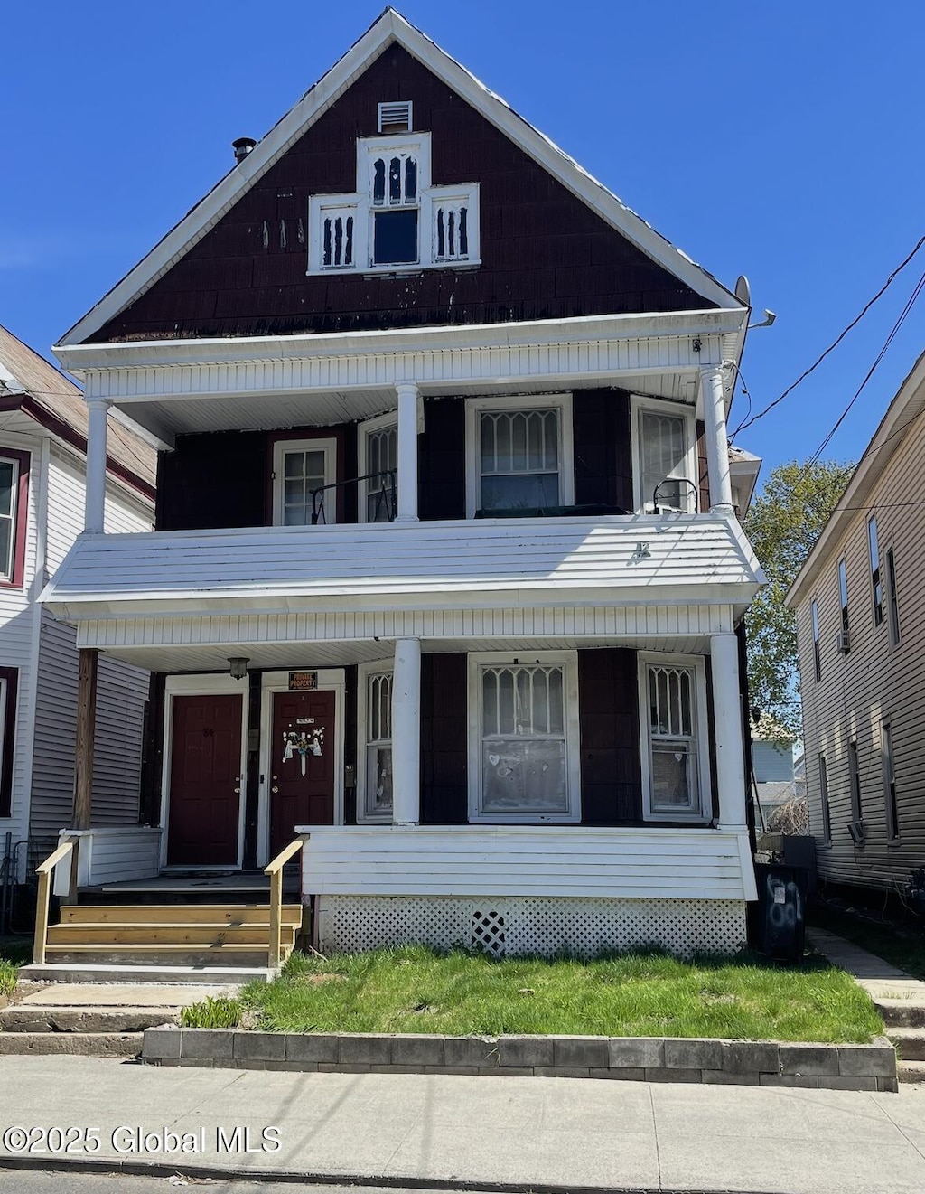 view of front facade featuring a balcony and a porch