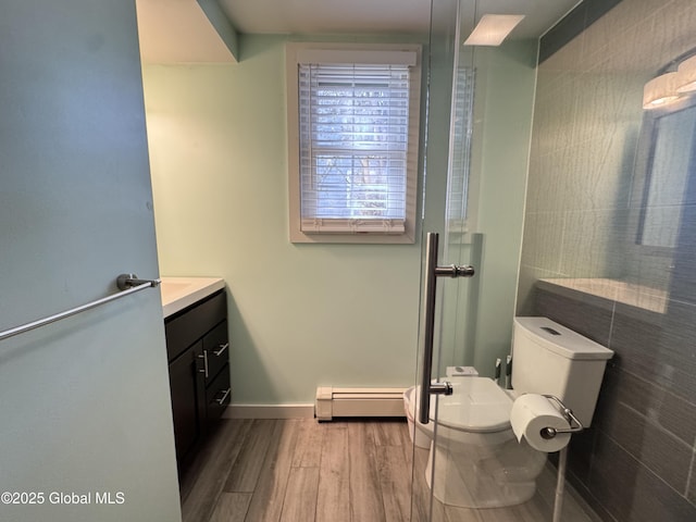 14 Wendom Rd, Albany, NY 12203 - bathroom featuring a baseboard radiator, wood finished floors, vanity, toilet, and baseboards