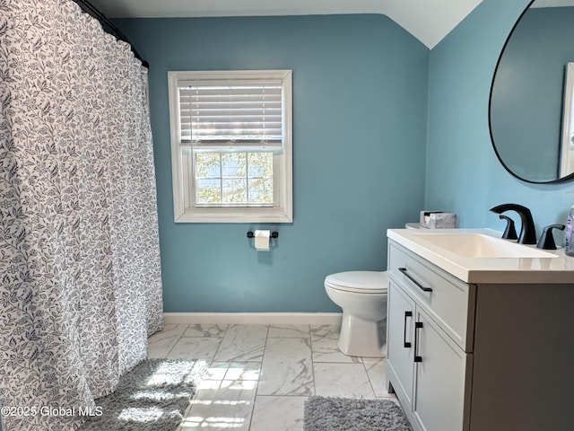 14 Wendom Rd, Albany, NY 12203 - full bath with marble look tiles, vanity, toilet, baseboards, and lofted ceiling
