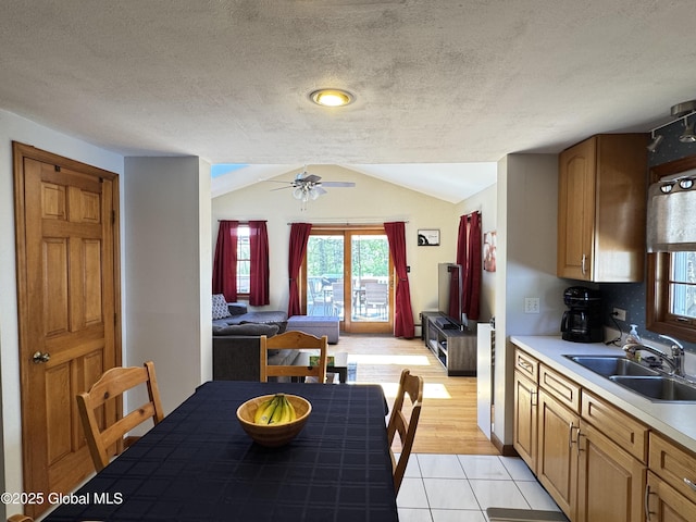 14 Wendom Rd, Albany, NY 12203 - kitchen featuring a sink, light countertops, lofted ceiling, a ceiling fan, and light tile patterned floors