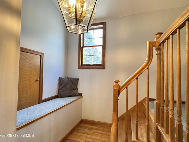 14 Wendom Rd, Albany, NY 12203 - stairway with wood finished floors, a chandelier, and baseboards