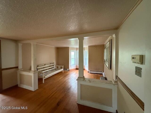 153 River St, Queensbury, NY 12845 - hall featuring ornate columns, wood finished floors, baseboard heating, a textured ceiling, and baseboards