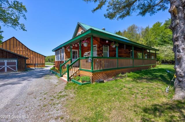 116 Medbury Rd, Greenfield, NY 12859 - view of front of house featuring a front lawn, a porch, metal roof, and gravel driveway
