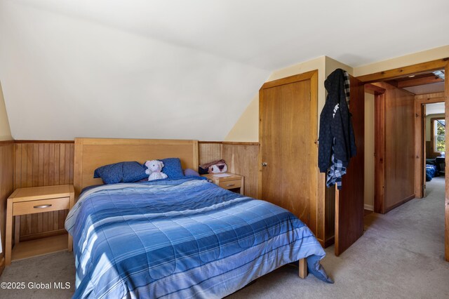 116 Medbury Rd, Greenfield, NY 12859 - bedroom featuring wood walls, light carpet, lofted ceiling, and wainscoting