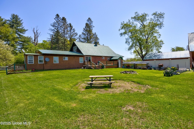 116 Medbury Rd, Greenfield, NY 12859 - rear view of house with a fire pit and metal roof