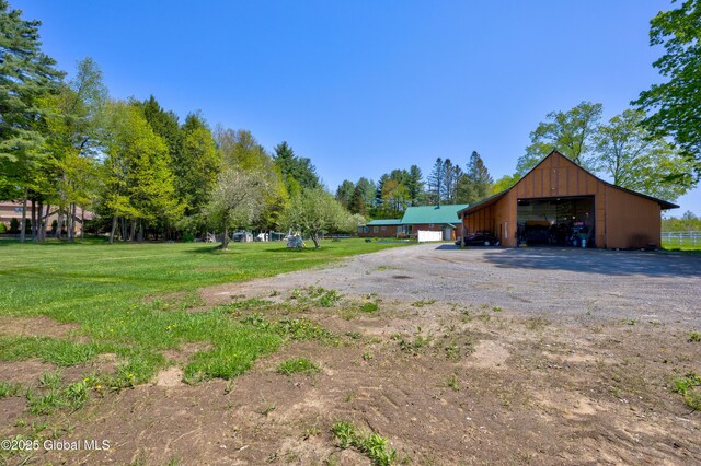 116 Medbury Rd, Greenfield, NY 12859 - view of yard featuring a pole building, a detached garage, an outdoor structure, and dirt driveway