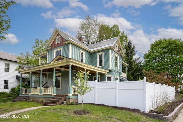 185 Bay St, Glens Falls, NY 12801 - victorian home featuring a porch and a chimney