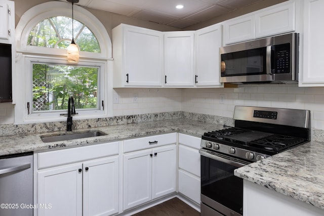 185 Bay St, Glens Falls, NY 12801 - kitchen with appliances with stainless steel finishes, a sink, light stone counters, backsplash, and recessed lighting