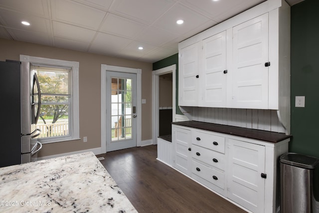 185 Bay St, Glens Falls, NY 12801 - kitchen with freestanding refrigerator, dark wood finished floors, recessed lighting, white cabinets, and baseboards