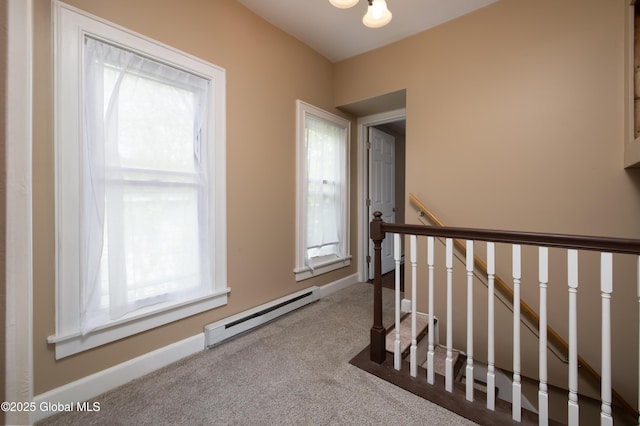 185 Bay St, Glens Falls, NY 12801 - hallway featuring a baseboard heating unit, healthy amount of natural light, carpet, and an upstairs landing