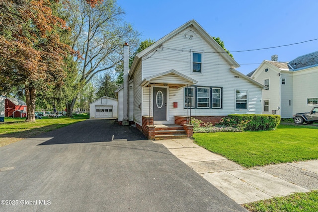 22 Center St, Fort Edward, NY 12828 - traditional-style house featuring an outbuilding, a detached garage, a front lawn, and driveway