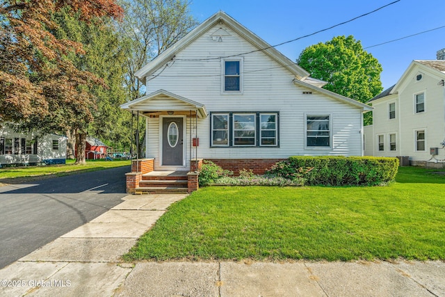 22 Center St, Fort Edward, NY 12828 - view of front of property with a front yard and central air condition unit