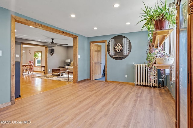 22 Center St, Fort Edward, NY 12828 - living area with wood finished floors, recessed lighting, radiator heating unit, ceiling fan, and baseboards