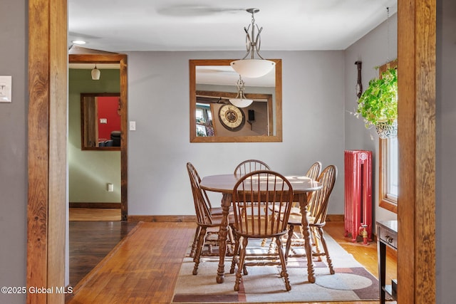 22 Center St, Fort Edward, NY 12828 - dining area featuring radiator, wood finished floors, and baseboards