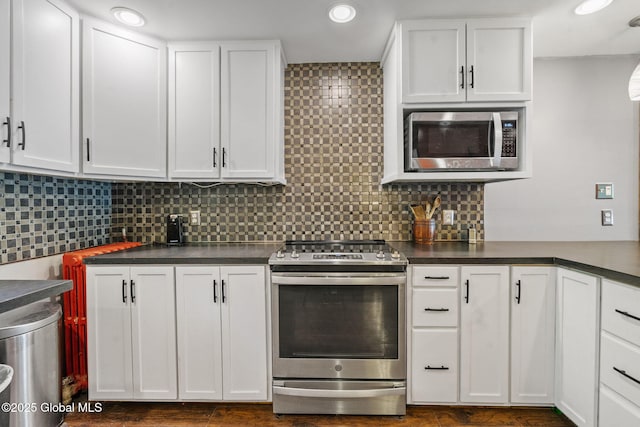 22 Center St, Fort Edward, NY 12828 - kitchen featuring appliances with stainless steel finishes, dark countertops, white cabinetry, decorative backsplash, and recessed lighting