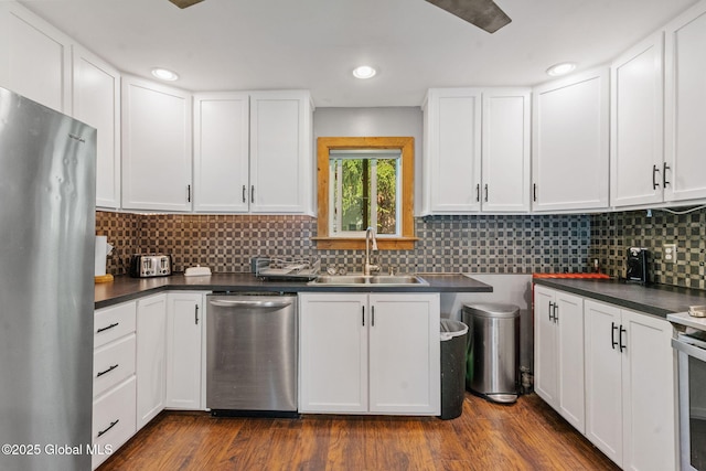 22 Center St, Fort Edward, NY 12828 - kitchen featuring appliances with stainless steel finishes, a sink, dark countertops, white cabinetry, and recessed lighting