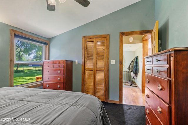 22 Center St, Fort Edward, NY 12828 - bedroom featuring lofted ceiling, radiator heating unit, a closet, a ceiling fan, and dark carpet
