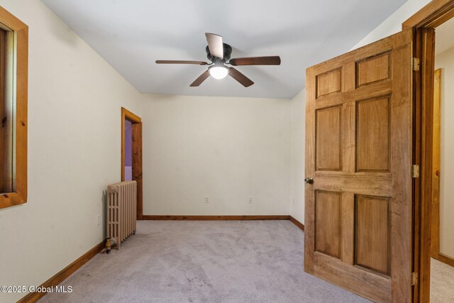22 Center St, Fort Edward, NY 12828 - empty room with radiator, light colored carpet, a ceiling fan, and baseboards