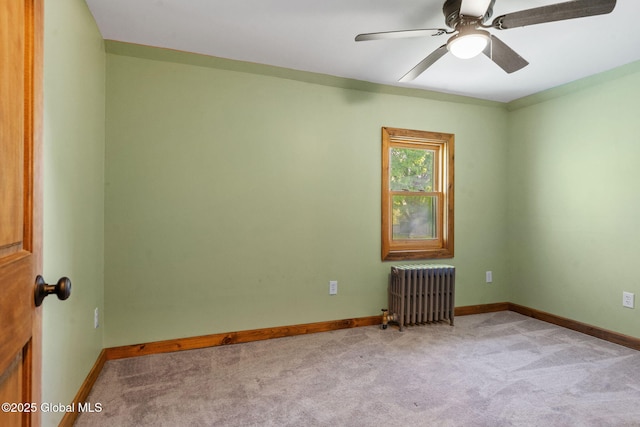 22 Center St, Fort Edward, NY 12828 - spare room with radiator heating unit, light colored carpet, baseboards, and ceiling fan