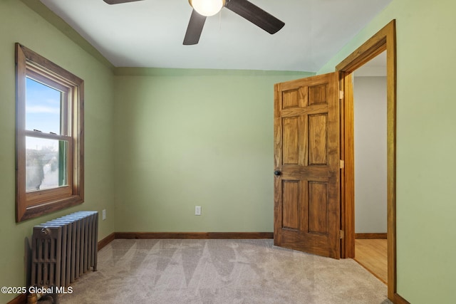 22 Center St, Fort Edward, NY 12828 - spare room featuring radiator heating unit, light colored carpet, a ceiling fan, and baseboards