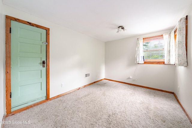 carpeted empty room with baseboards