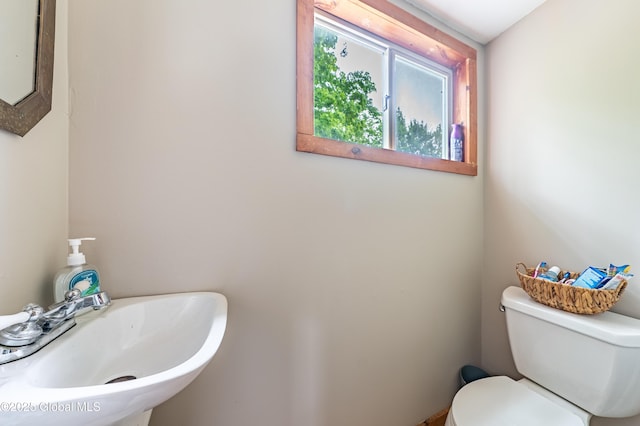 half bathroom with a sink and toilet