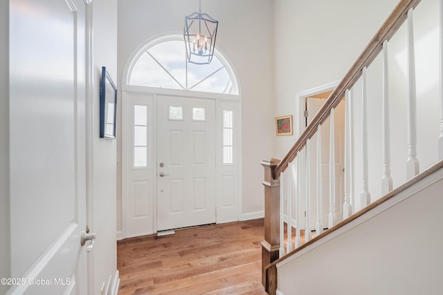 36 Greystone Dr, Guilderland, NY 12186 - entryway featuring light wood-type flooring, stairway, and a chandelier