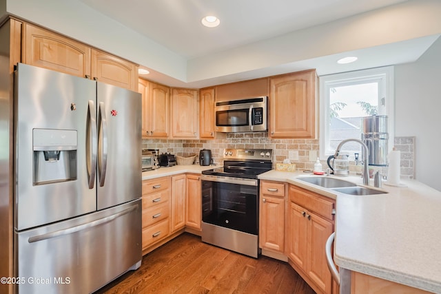 36 Greystone Dr, Guilderland, NY 12186 - kitchen featuring appliances with stainless steel finishes, a sink, light brown cabinetry, wood finished floors, and light countertops