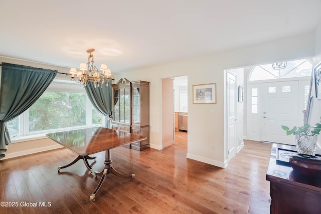 36 Greystone Dr, Guilderland, NY 12186 - dining room featuring a chandelier, plenty of natural light, light wood finished floors, and baseboards