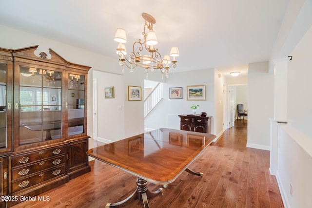 36 Greystone Dr, Guilderland, NY 12186 - dining area with wood finished floors, stairway, a chandelier, and baseboards