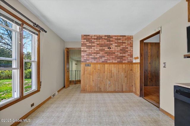 60 Edmund Dr, Milton, NY 12020 - unfurnished living room with wood walls, plenty of natural light, light flooring, a wainscoted wall, and baseboards