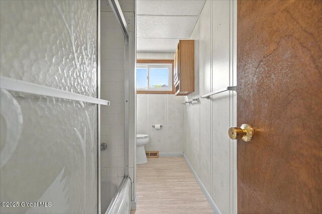 60 Edmund Dr, Milton, NY 12020 - bathroom with toilet, wood finished floors, and shower / bath combination with glass door