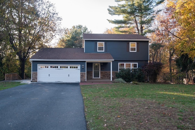 18 Alva St, East Greenbush, NY 12061 - view of front of home featuring asphalt driveway, a garage, stone siding, a front yard, and a porch
