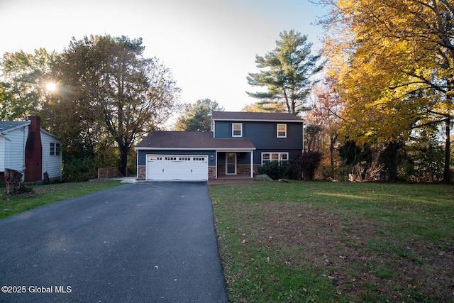 18 Alva St, East Greenbush, NY 12061 - traditional home with driveway, an attached garage, a front yard, and stone siding