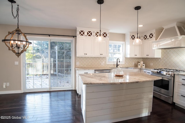 18 Alva St, East Greenbush, NY 12061 - kitchen featuring stainless steel range with gas stovetop, a sink, premium range hood, white cabinetry, and decorative backsplash