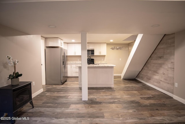 18 Alva St, East Greenbush, NY 12061 - kitchen featuring appliances with stainless steel finishes, baseboards, a wood stove, white cabinets, and recessed lighting