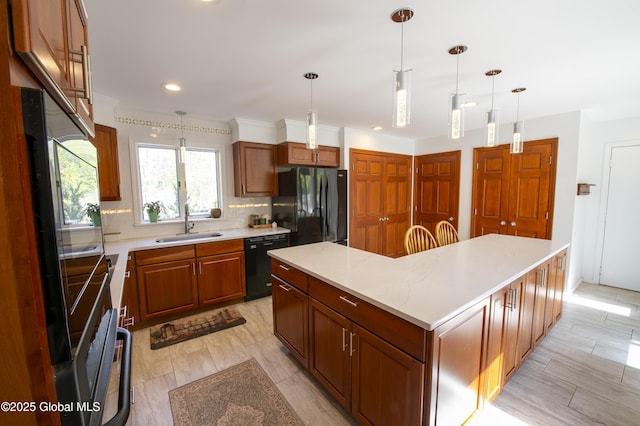 kitchen with black appliances, a sink, light countertops, decorative backsplash, and a center island