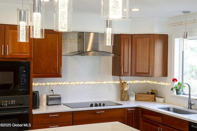 kitchen with wall chimney exhaust hood, black appliances, a sink, tasteful backsplash, and light countertops
