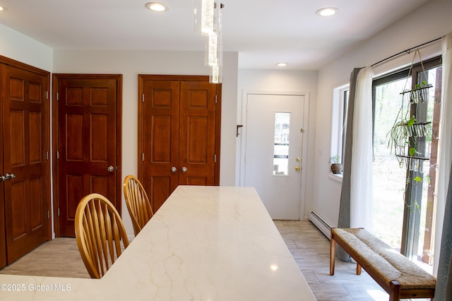 dining room featuring recessed lighting, a baseboard radiator, and light wood-style floors