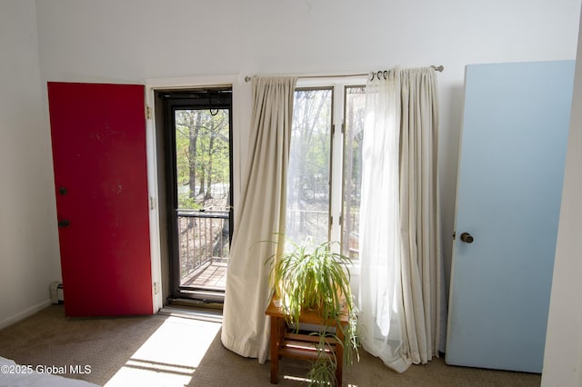 doorway featuring carpet flooring and a baseboard radiator
