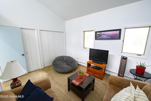 living area featuring light carpet, baseboard heating, healthy amount of natural light, and high vaulted ceiling