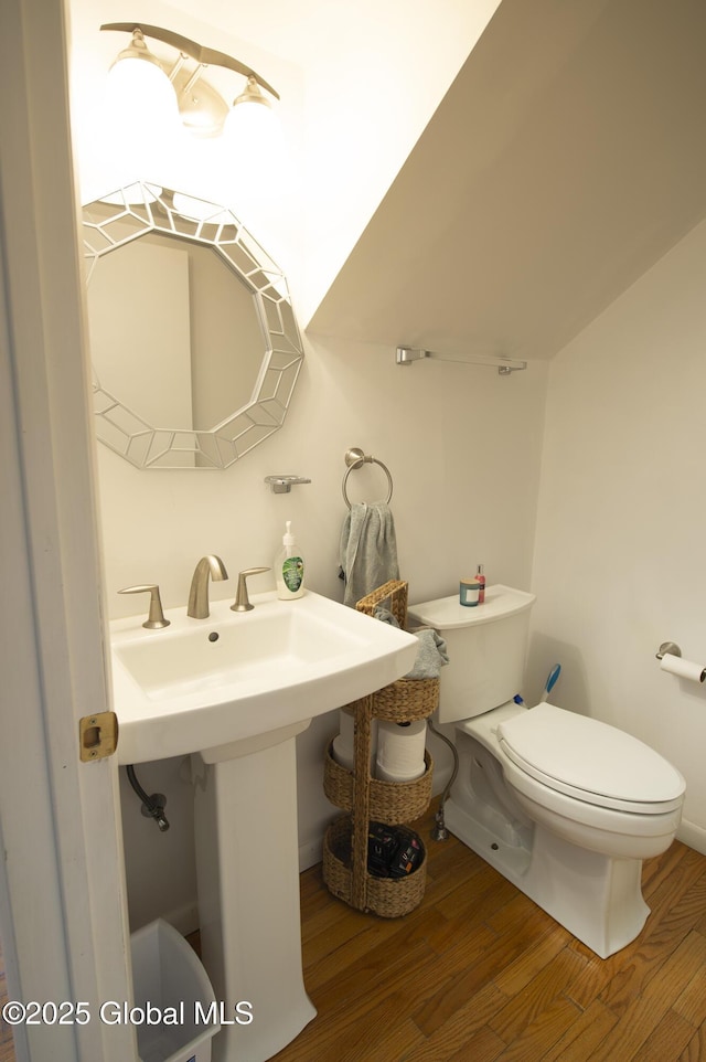 half bath with wood finished floors and toilet