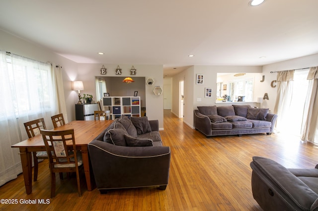 living room with healthy amount of natural light, wood finished floors, recessed lighting, and baseboards