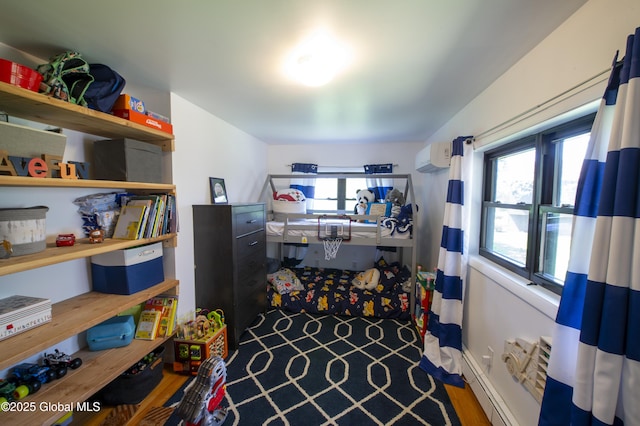 storage room with a baseboard radiator and a wall unit AC