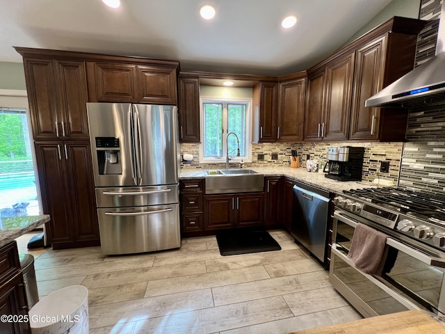 25 Hilton Dr, Moreau, NY 12803 - kitchen with appliances with stainless steel finishes, a sink, wall chimney range hood, healthy amount of natural light, and recessed lighting
