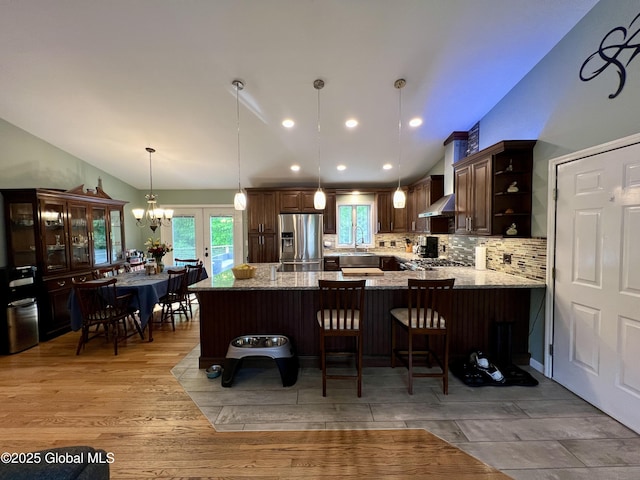 25 Hilton Dr, Moreau, NY 12803 - kitchen featuring stainless steel fridge with ice dispenser, open shelves, light stone countertops, a peninsula, and backsplash