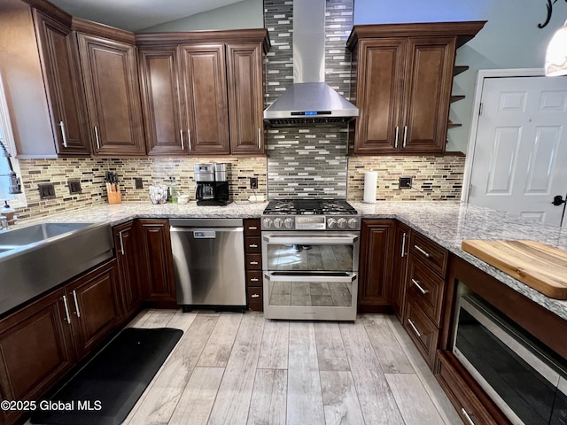 25 Hilton Dr, Moreau, NY 12803 - kitchen featuring appliances with stainless steel finishes, wall chimney exhaust hood, light wood-style floors, open shelves, and decorative backsplash