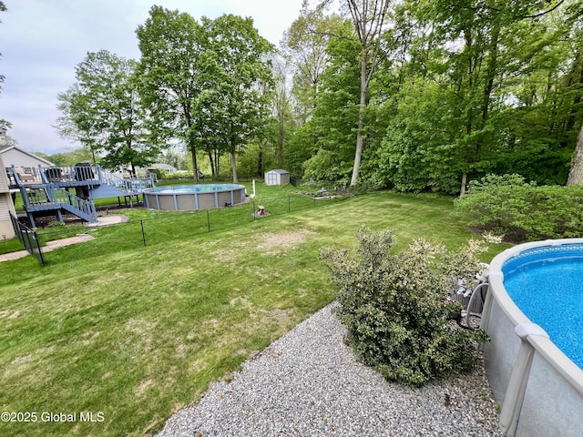 25 Hilton Dr, Moreau, NY 12803 - view of yard featuring an outdoor pool, a shed, and an outbuilding