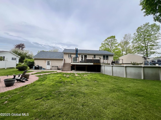 25 Hilton Dr, Moreau, NY 12803 - rear view of house with a deck, a patio area, a yard, stairway, and an outdoor pool